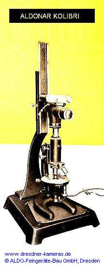 ALDONAR Kolibri mit federnd gelagertem Standardanschluss zur flexiblen Montage der Kamera am Mikroskopokular mittels des abgebildeten ALDO-Stativs